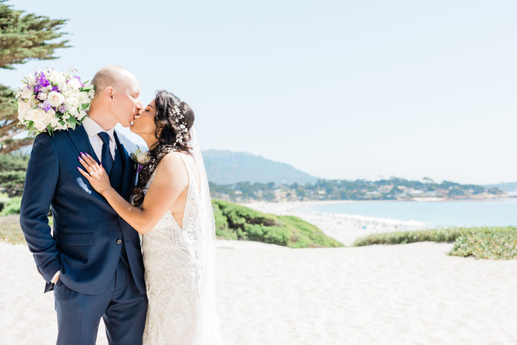 Carmel wedding couple sharing a kiss at the beach