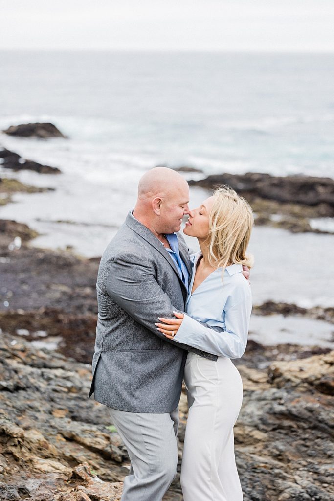 engagement photo couple kissing near the ocean