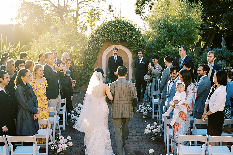 La Playa Hotel Wedding walking down the aisle